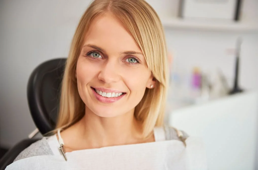 happy woman with a beautiful smile at dentist